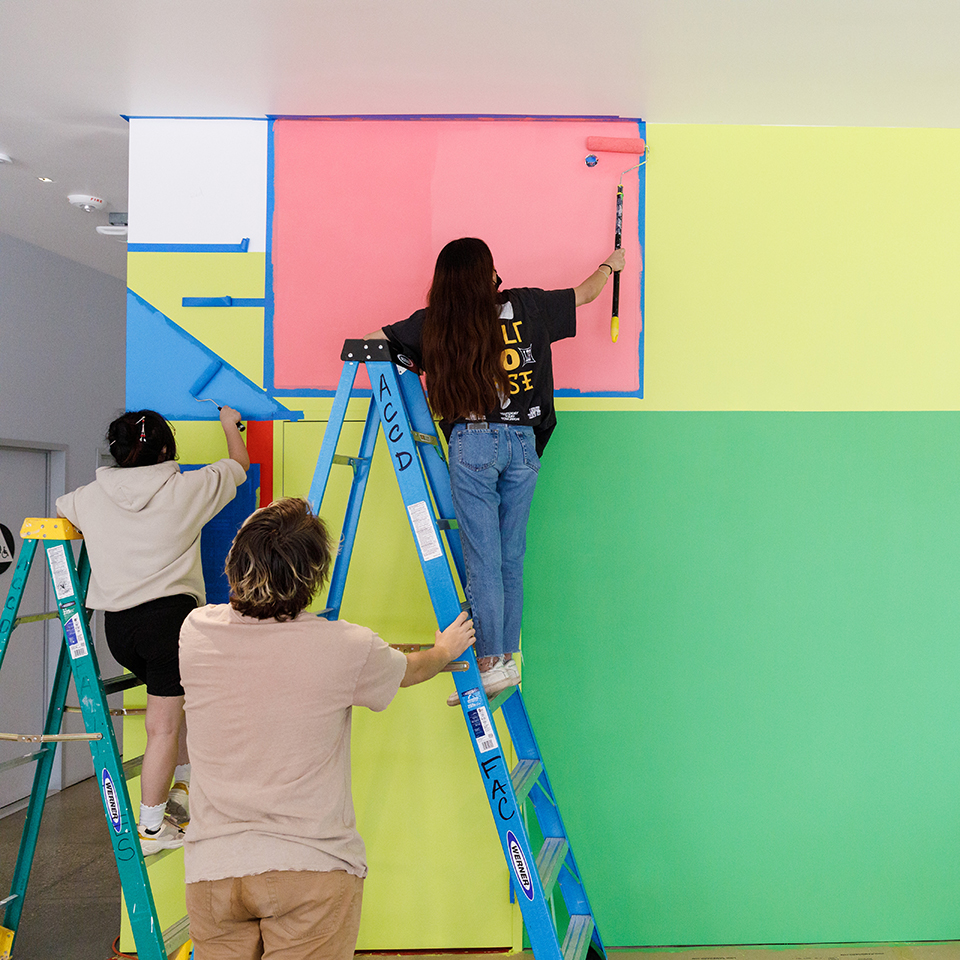 students painting a mural