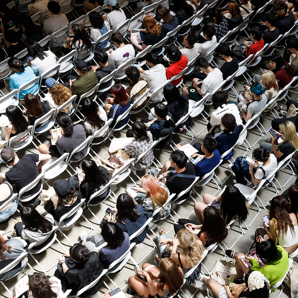 View from above of students sitting in rows of chairs
